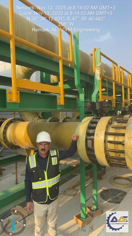 Pipe rack for the Nano-Filtration (NF) building: yellow process piping on a steel rack with a worker on the platform