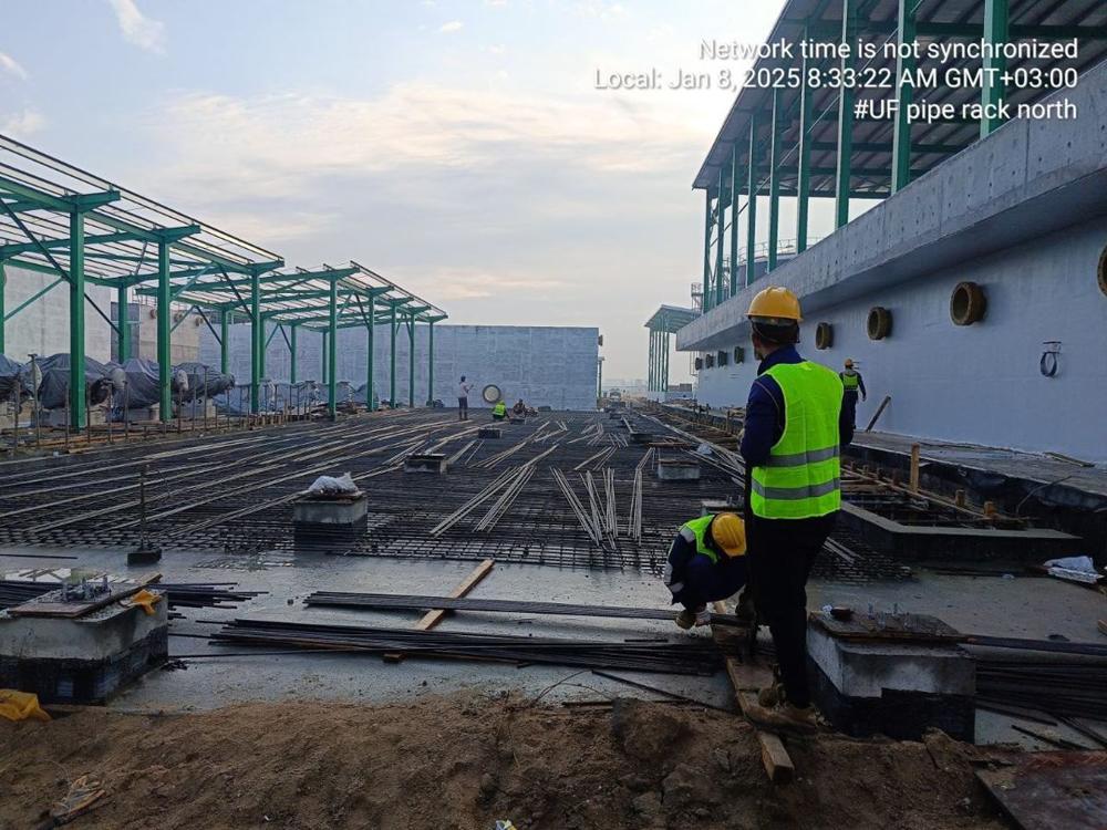 UF pipe rack under construction: foundation and reinforcement, steel canopy structure beyond